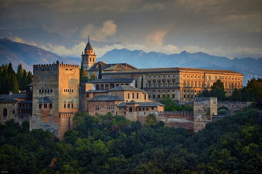 The Alhambra in Granada stands golden under the winter skies