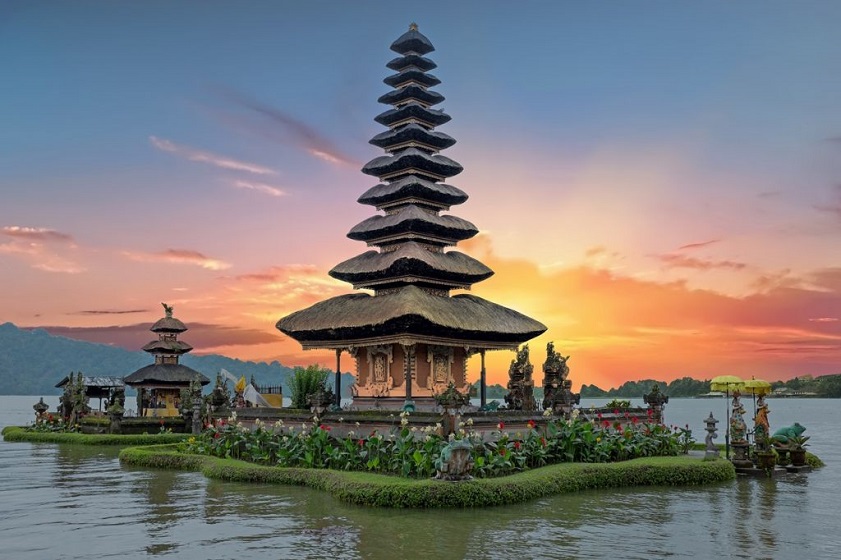 Best countries to visit from Hong Kong A traditional Balinese temple glows at sunset amid lush tropical scenery